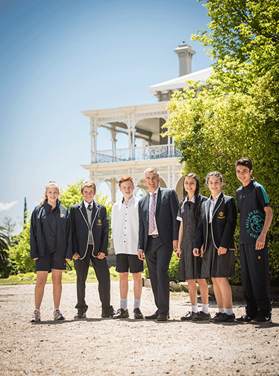 Image of a principal with some of his students